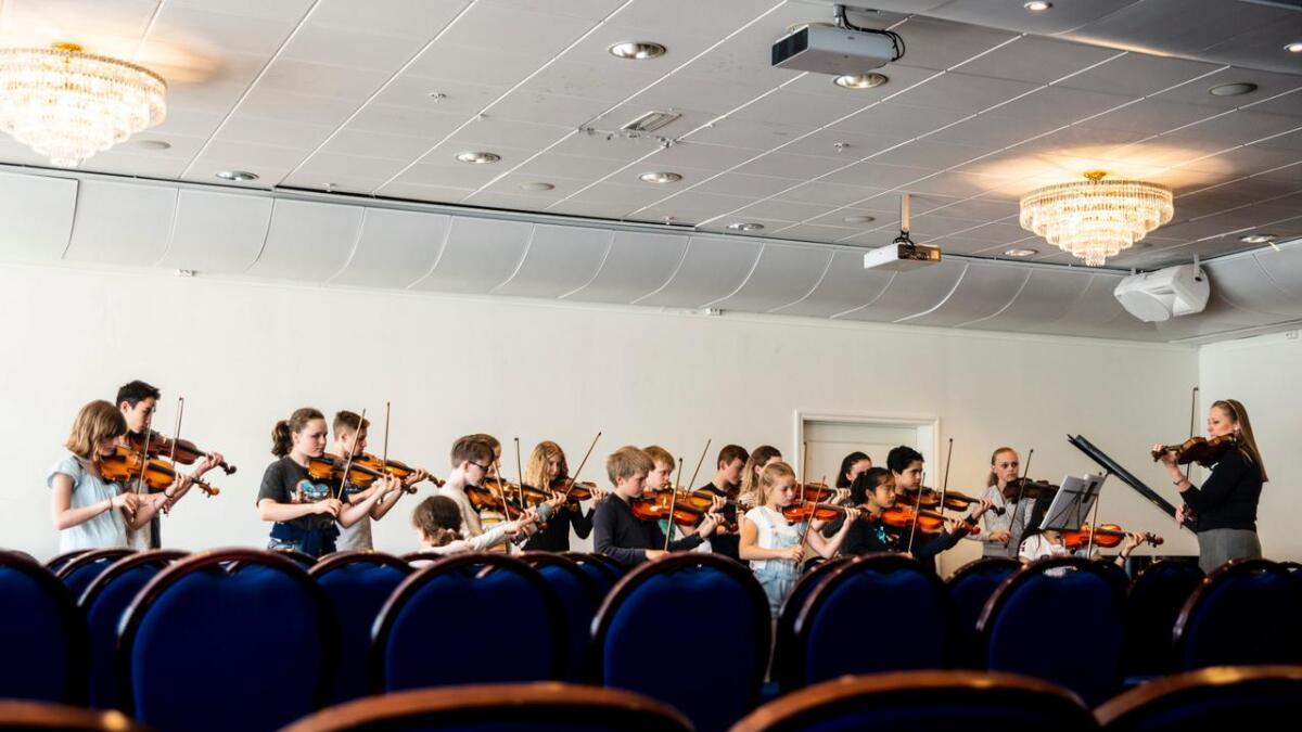 Kring 20 unge fiolinistar øver på Bach sin Dobbel fiolinkonsert. Utan notar.