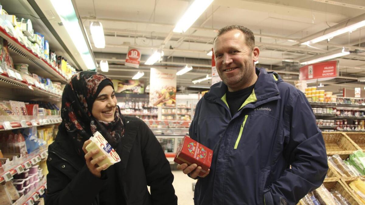 Razan (t.v.) og Samir har funne fram til norske godsaker i hylla på Spar, ein av plassane Samir syter for at er reint og fint.